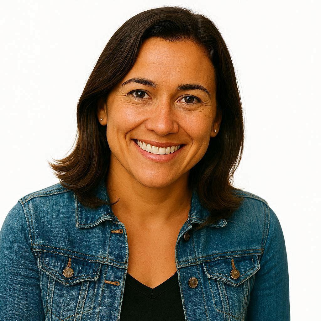 Portrait of a woman with short hair and a warm smile, wearing a green utility shirt
